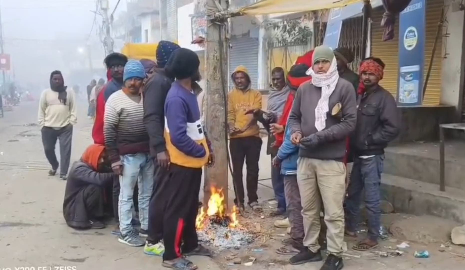 अलाव का सहारा लेते लोग